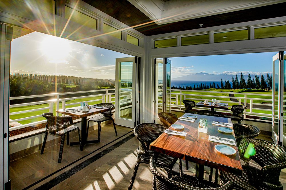 Guests enjoying brunch at Plantation House with ocean views in Lahaina, Maui.